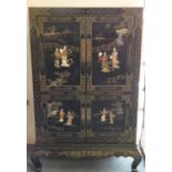 A Chinese black lacquer cabinet, the four doors and sides decorated with carved hardstone, ivory and