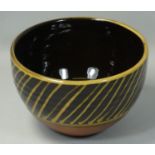 Peter Dick (1936 - 2012), a small bowl with black and yellow sgraffito decoration, ochre coloured