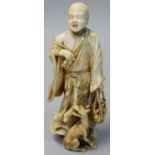 A Japanese Meiji Period Ivory Okimono, carved to depict a man with a basket of fruit with a dog at