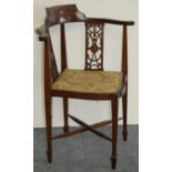 An Edwardian mahogany and boxwood inlaid corner chair, with pierced splats and upholstered seat.