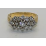 An 18ct gold and diamond cluster ring, panel set with brilliant cut stones, total weight