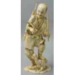 A Japanese Ivory Meiji Period sectional Okimono, in the form of a man with a bird, spears on his