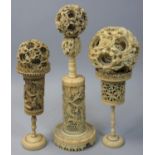 A 19th century Cantonese ivory puzzle ball on stand, the outer ball with figures, four further balls