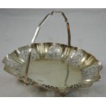 A silver swing handle basket, Sheffield 1911, of oval form with pierced border, raised on four