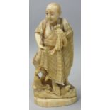 A Japanese Meiji Period Ivory Okimono, in the form of a fisherman with his net and fish, signed,