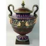 A 19th century Majolica two handle lidded vase, unmarked, the urn shape body with a band of winged