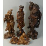 A Chinese rootwood carved group, depicting a lady with child, 19 cm and three carved figures of