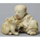 A Japanese Ivory Netsuke, carved in the form of a man with a dog, signed, height 3.5cm.