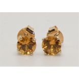 A pair of 9k citrine ear studs, claw set with brilliant cut stones.