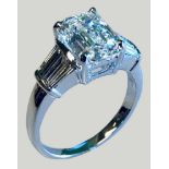 An 18ct white gold single stone certificated diamond ring, claw set with a 3.4 ct emerald cut stone,