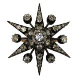 A Victorian silver set, gold mounted diamond star brooch, c.1880, the central old cut stone of