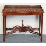 A reproduction mahogany silver table, with pierced and shaped gallery, over tapering legs with