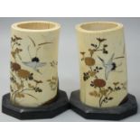 A Japanese pair of ivory and shibayama brush pots, decorated with mother of pearl storks amongst