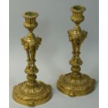 A Victorian pair of cast gilt metal candlesticks, with Ram's head and leg decoration, 22 cm.