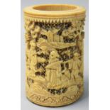 A Chinese Canton carved and pierced brush pot, decorated with people amongst trees and buildings,
