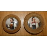 A pair of Continental porcelain circular panels, decorated with portraits of Swiss ladies,
