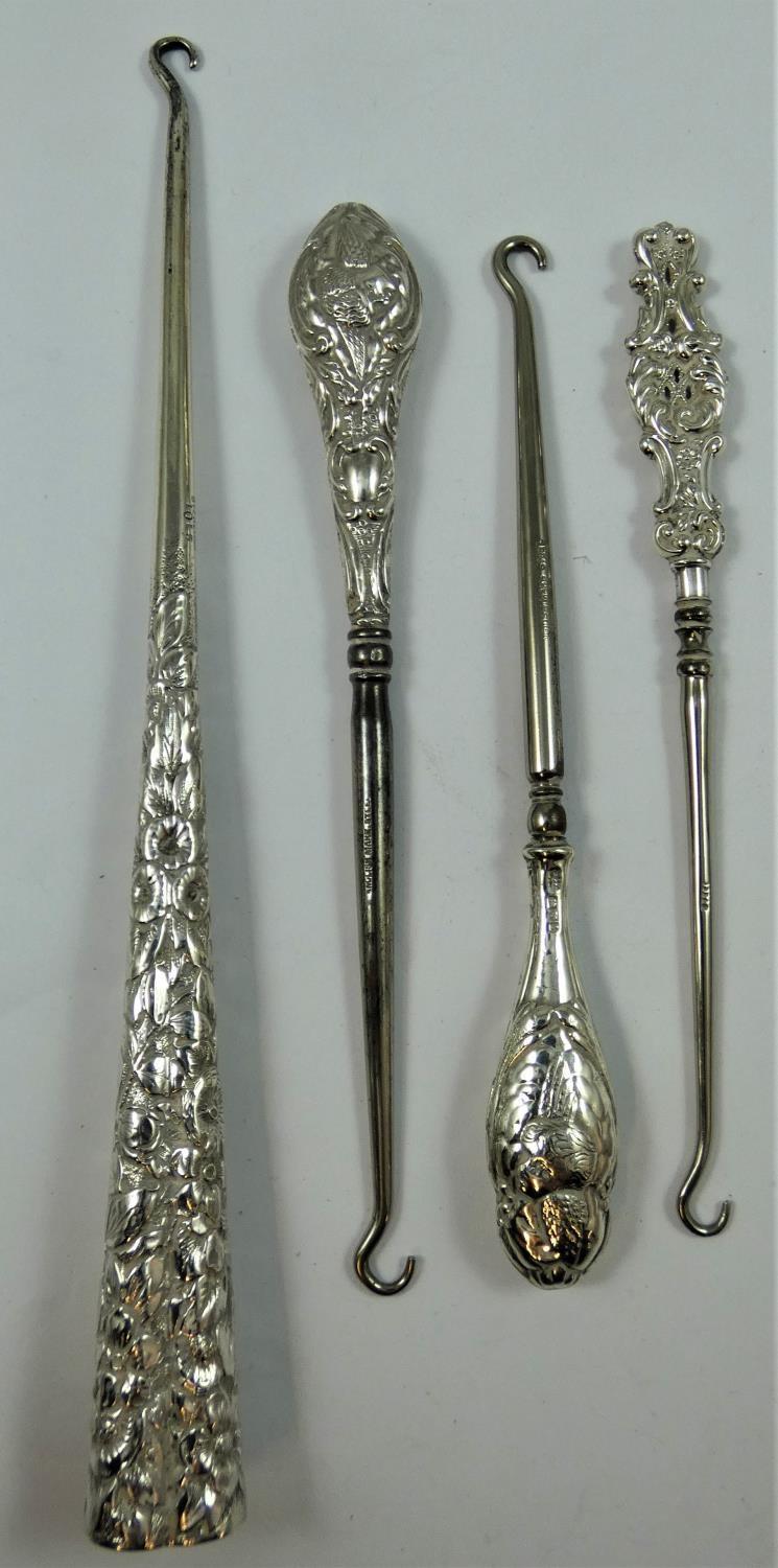 A late 19th century/early 20th century sterling silver button hook, the trefoil tapering handle