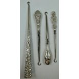 A late 19th century/early 20th century sterling silver button hook, the trefoil tapering handle