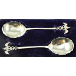 An Edwardian pair of silver Caducus serving spoons, by James Deakin, Sheffield 1903, with cast