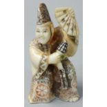 A Japanese Ivory Netsuke, carved and painted as a man with a fan, signed, height 6 cm.