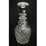 A cut glass decanter with silver rim, Birmingham 1928, with mushroom stopper, 27 cm.