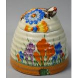 A Clarice Cliff Bizarre beehive preserve pot, crocus pattern, 9.5 cm.