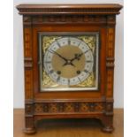 An Edwardian walnut and marquetry inlaid mantle clock, the gilt dial with silvered chapter ring, the