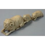 A Japanese Ivory Okimono, carved to depict a row of three rams, unsigned, length 14.5 cm.