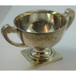 A silver two handled trophy bowl, Birmingham 1924, of plain form, raised on a pedestal foot,