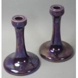 A pair of Ruskin art pottery candlesticks, c. 1925, with purple lustre decoration, impressed