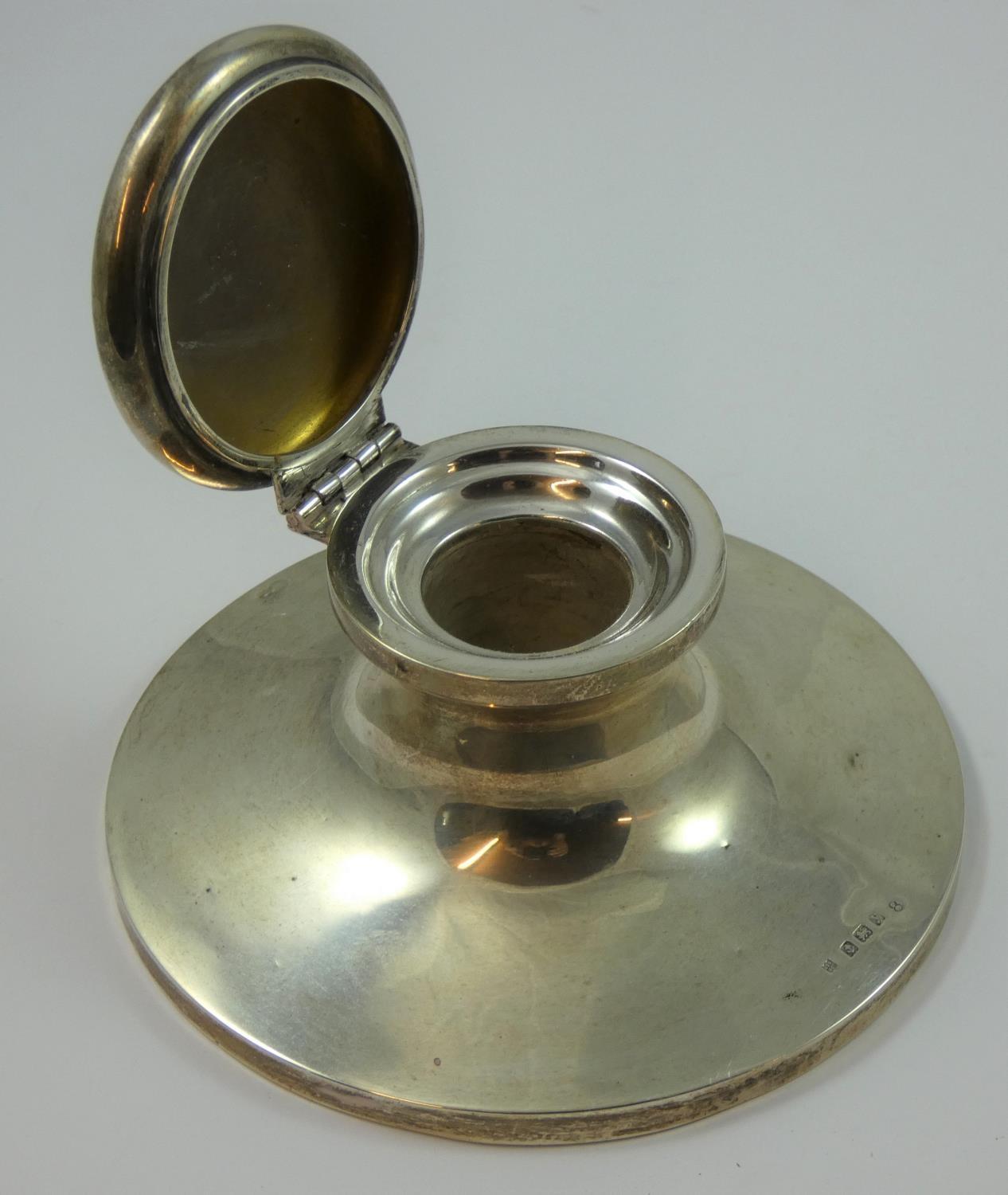 A silver capstan inkwell, Birmingham 1923, of circular form, lacking liner, diameter 13 cm, loaded.