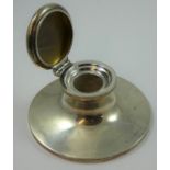 A silver capstan inkwell, Birmingham 1923, of circular form, lacking liner, diameter 13 cm, loaded.
