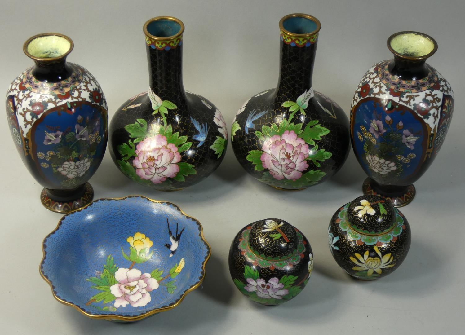 A pair of Chinese cloisonne baluster vases, with black field, blue birds and pink flower heads,