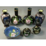 A pair of Chinese cloisonne baluster vases, with black field, blue birds and pink flower heads,