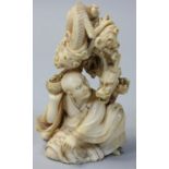 A Japanese Ivory Meiji Period Okimono, in the form of a man holding a bowl with a dragon emerging