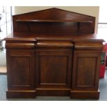 A Victorian mahogany reverse breakfront side board, with shelved back board, three frieze drawers