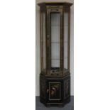 A Chinoiserie black painted octagonal display cabinet, with gilt decoration, the lower panels
