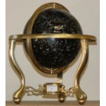 A modern desk globe with brass fittings.