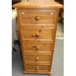 A pine five height chest of drawers, 116cm tall, 51cm wide.