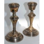 A silver pair of candlesticks, Birmingham 1976, of baluster form, 14 cm, loaded.