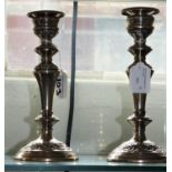 A silver pair of candlesticks, Birmingham 1973, with embossed baluster stems, 23 cm, loaded.