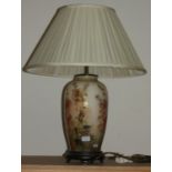 A floral ceramic table lamp with fabric shade.