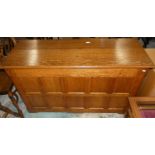 A panelled oak coffer, 128cm long, 76cm tall, 47cm wide.