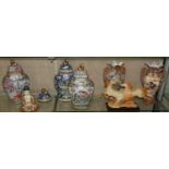 A pair of Oriental twin handled vases with flared rims, together with three lidded urns each with