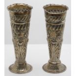 A Victorian silver pair of flower vases, Birmingham 1900, with embossed decoration, 11 cm, loaded
