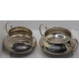 A silver sugar bowl and milk jug, Birmingham 1923, with gadrooned borders, 9.5 oz.