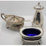 A silver three piece cruet, Sheffield 1926, of baluster form, blue glass liners, 6.5 oz.