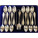 A Victorian Scottish silver set of twelve tea spoons, sugar scoop and tongs, Glasgow 1890, with