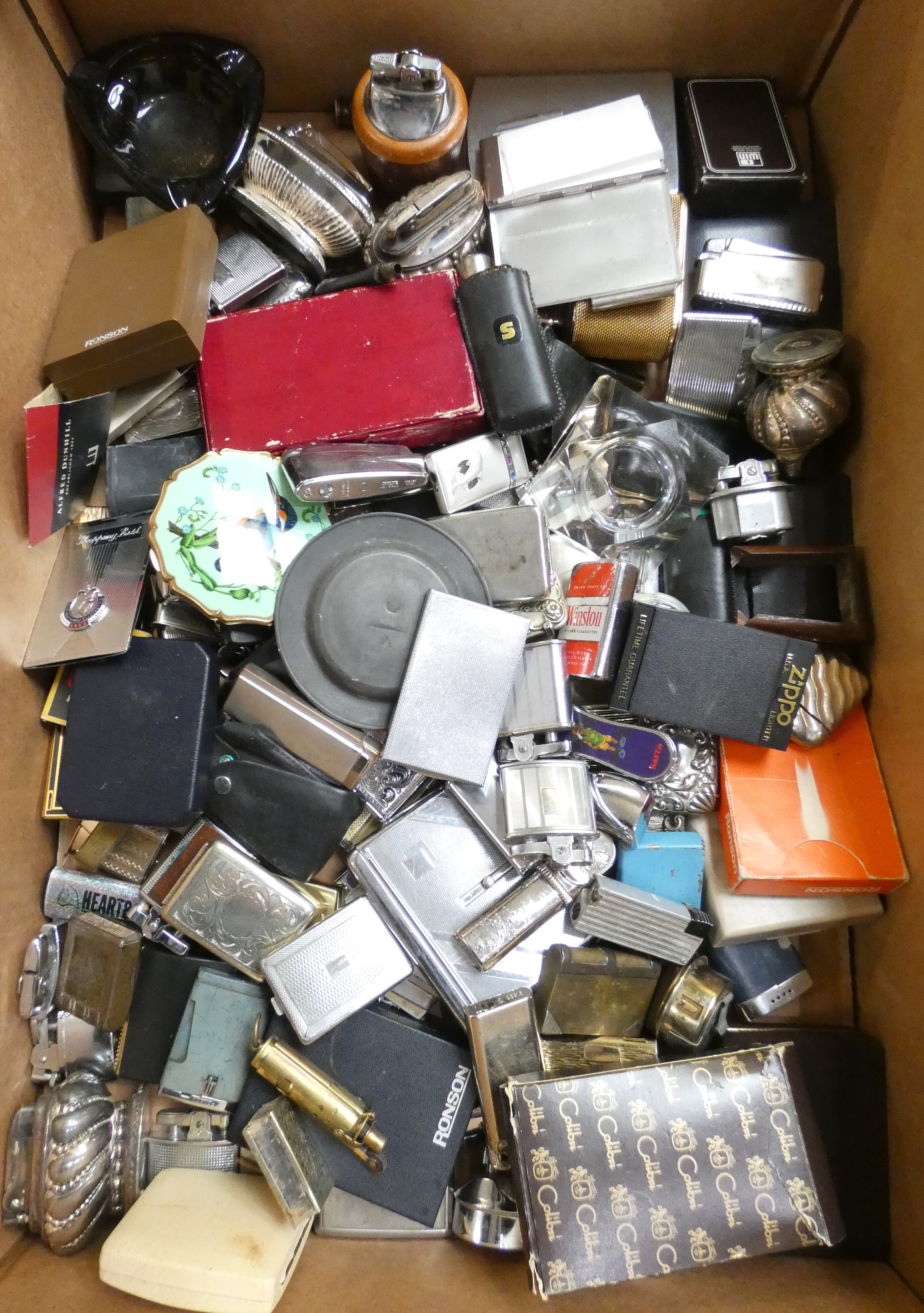 A large collection of cigarette lighters, various makers