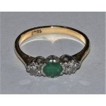 An 18ct gold, emerald and diamond three stone ring set with brilliant cut stones